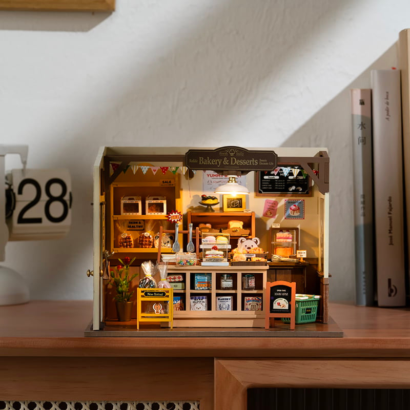 Miniature bakery interior with bread, pastries, and rustic shelves.